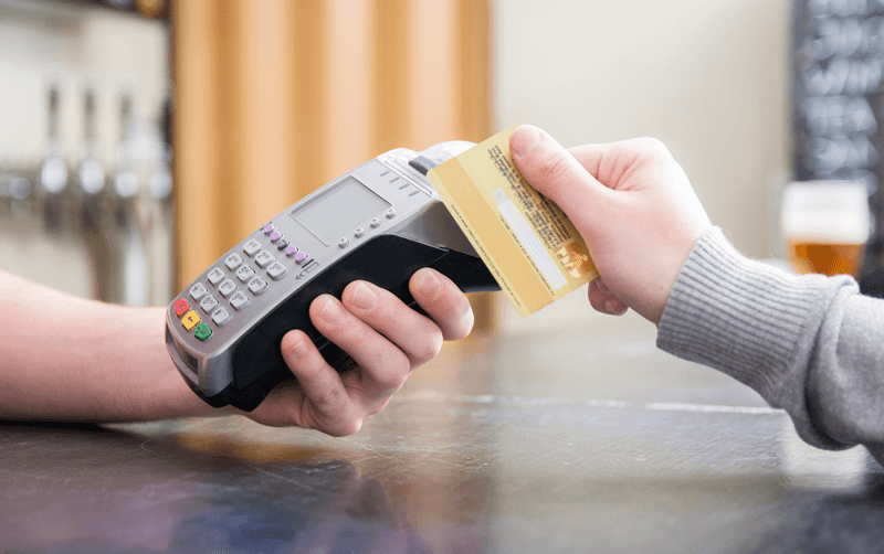 Pessoa passando cartão de crédito