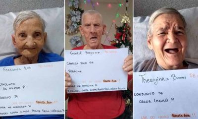 três idosos seguram cartaz com seus nomes, idades e presentes desejados para o natal