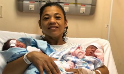 Mãe segurando recém-nascidos gêmeos