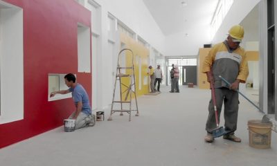 Pedreiros e pintores em construção de unidade escolar