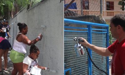 Mulheres e crianças pintando muros, à esquerda; homem pintando portão, à direita