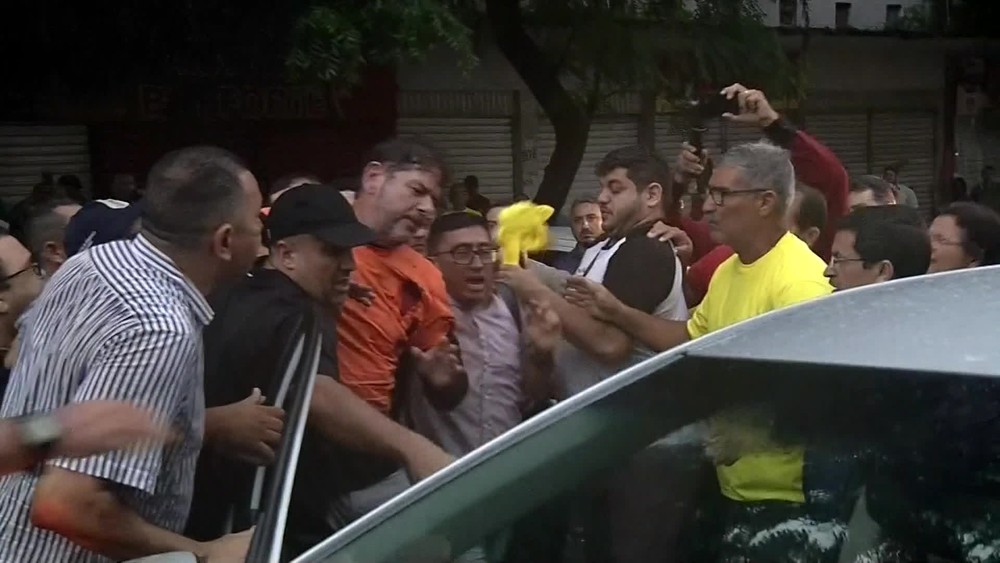 homem sendo socorrido após levar um tiro