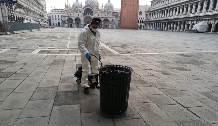 Foto de colaborador realizando higienização do espaço público de Veneza