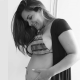 Mulher grávida segura barriga nas mãos