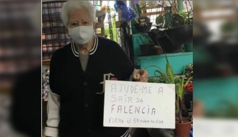 Seu Nelson com placa de "ajude-me a sair da falência"