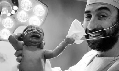 Bebê puxa máscara de médico após o parto