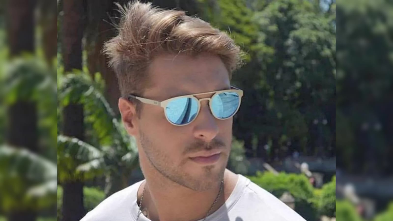 Homem de camisa branca e óculos de sol