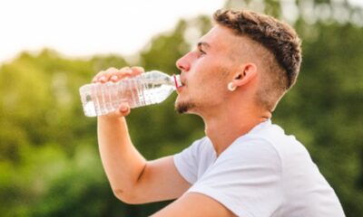 Homem com garrafa de água no calor