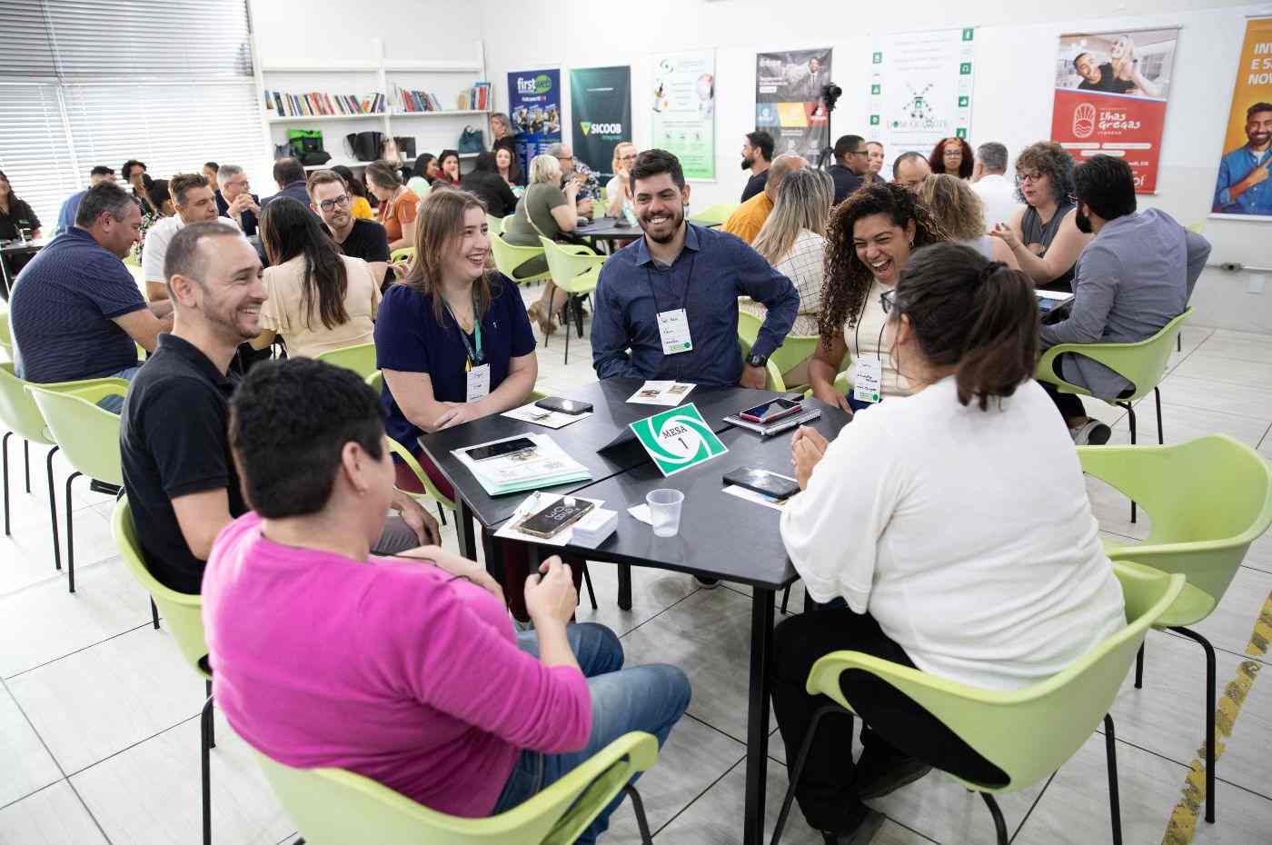 Empresários participando de uma Rodada de Negócios da ACE Jundiaí, em um ambiente de networking com várias mesas e interações.